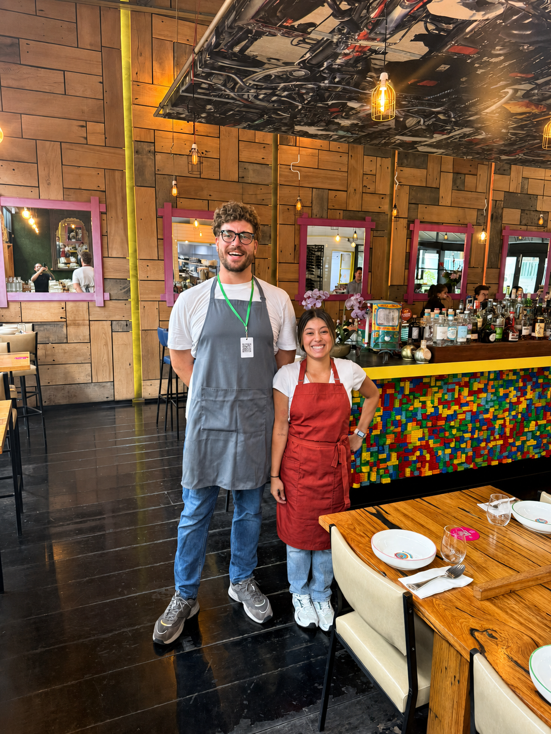 Two BangPop team members standing near the restaurant bar