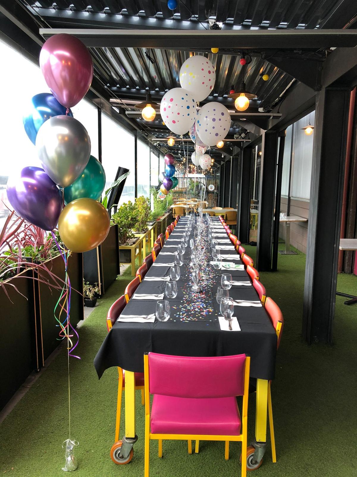 Tables arranged for an event on BangPop's terrace